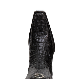 Close-up of a black crocodile-patterned boot