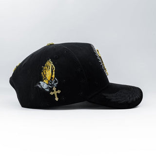 Black La Guadalupana Snapback with gold praying hands embroidery and jeweled cross.