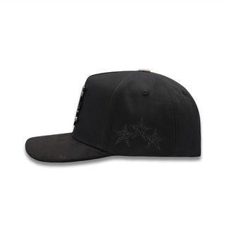Side profile showing embroidered black star accents and flat brim