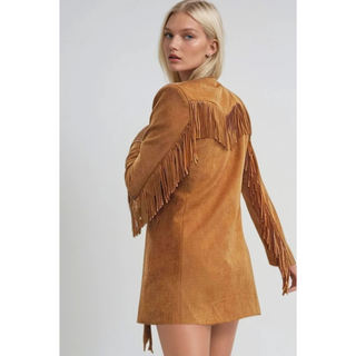 Woman wearing a camel faux suede western, styled in boho cowgirl fashion, back view
