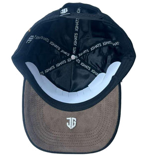 Black and brown cap with visible branding on a light gray background