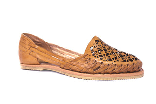 Side view of a classic honey colored leather huarache with a cut out designed face
