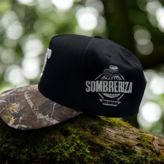 Side profile of JG Hats Culiacán Sombreriza snapback showing embroidered Sombreriza Culiacán patch and camouflage brim.