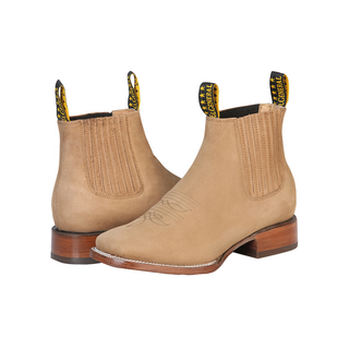Pair of tan Chelsea boots with brown soles 