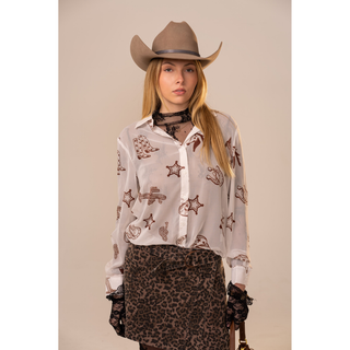 Women's white western print button-up shirt with brown cowboy icons styled with cowgirl hat