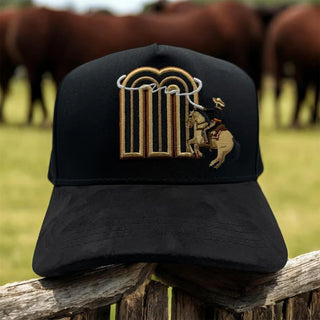 Front view of JG Hats M Rodeo Rider Black snapback cap featuring embroidered M logo with bronc rider design.