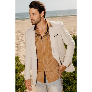 Model wearing men’s beige Platini modern fit stretch blazer styled with tan western shirt and light wash jeans at the beach