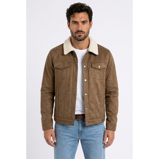 A man wearing a brown faux suede jacket with a cream sherpa collar, styled over a white t-shirt and blue jeans, photographed against a light gray studio background.