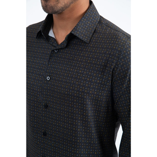 Man wearing a black and multi color long sleeve geometric print button-down shirt paired with jeans, modern men's fashion look- close up view 