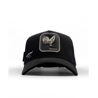 The King Ranch black trucker hat with silver rooster patch and curved brim