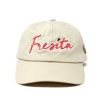 Front view of Khaki Fresita Dad Hat with embroidered red script and small strawberry detail on the letter i