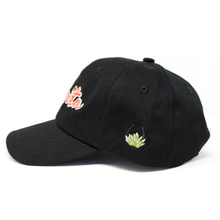 Side profile of embroidered black dad hat with MexWest logo