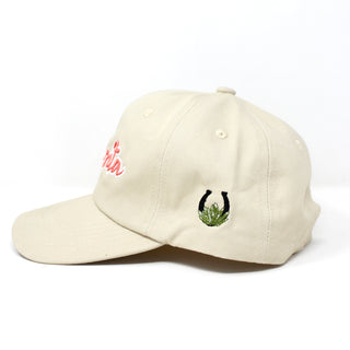 Side profile of embroidered khaki dad hat with MexWest logo