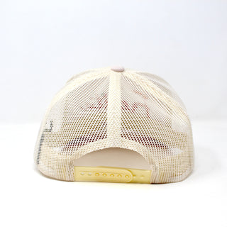Rear view of Fresita snapback cap showing adjustable white plastic snap closure and cream mesh panels