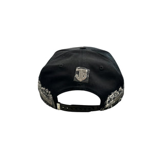 Back view of black JG snapback hat with silver emblem and adjustable snapback closure