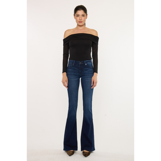 Model wearing dark wash flare jeans with heels