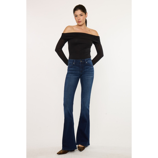 Model wearing dark wash flare jeans with heels
