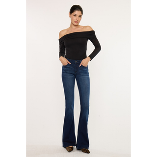 Model wearing dark wash flare jeans with heels