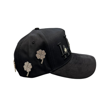 Side view of black LA streetwear snapback hat featuring silver rhinestone clover details