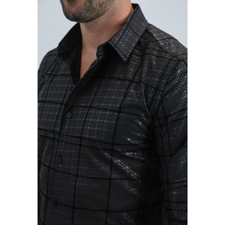 Man wearing a black long sleeve geometric print button-down shirt paired with jeans, modern men's fashion look- close up view of collar and button