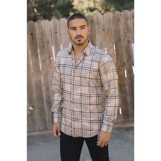 Man wearing a beige long sleeve geometric print button-down shirt paired with jeans, modern men's fashion look full profile view