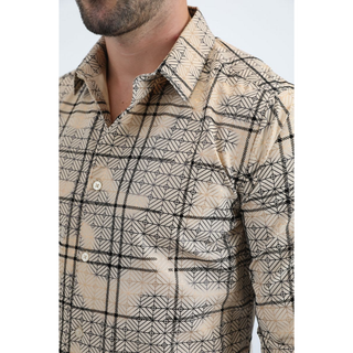 Man wearing a beige long sleeve geometric print button-down shirt paired with jeans, modern men's fashion look- close up view of collar and buttons