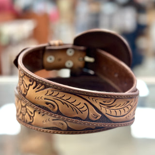 Brown leather belt with intricate embossed design on a blurred background