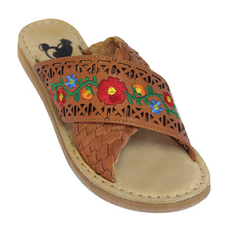Women’s tan Mexican leather slide sandals with colorful floral embroidery, decorative cutouts and braided crossover strap