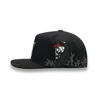 Side view of snapback showing embroidered demon skull with flames