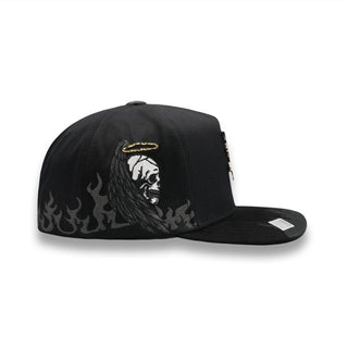 Side view of snapback showing embroidered angel skull with halo and flames