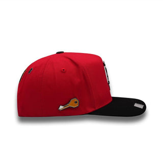 Side view of PERICO RED hat showing gold key pin