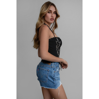 Side view of women’s black Raelynn embroidered western corset top styled with denim shorts.