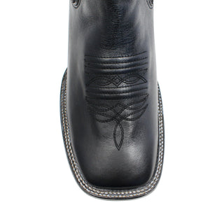 Toe close-up of a black leather boot with intricate stitching on a white background