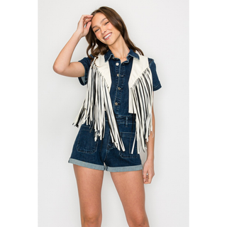Women's white western fringe vest styled over denim romper