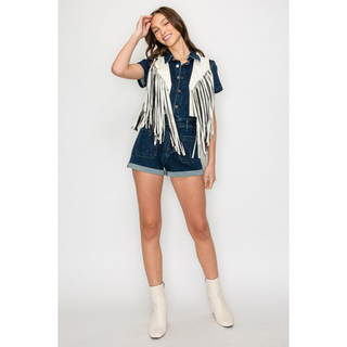 Women's white western fringe vest styled over denim romper