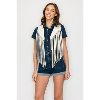 Women's white western fringe vest styled over denim romper