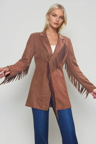 Woman wearing a camel faux suede western, styled in boho cowgirl fashion