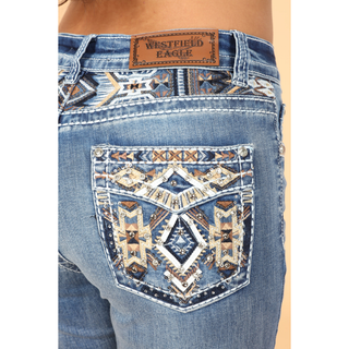 Close-up of embroidered faux flap back pocket featuring faux leather, rhinestones, sequins, and western embroidery on Westfield Eagle jeans.