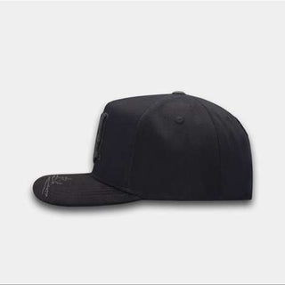 Black cap with white angel design on a white background