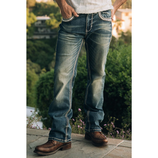Outdoor photo of Platini Holt slim boot cut jeans in natural light, showing fading and Western-style stitching.