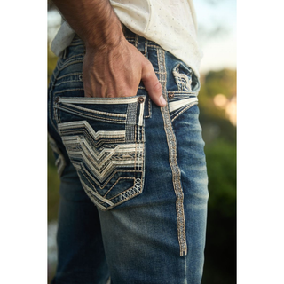 Side back view of Platini Holt jeans with a hand in the pocket, focusing on pocket embroidery and outer seam stitching.