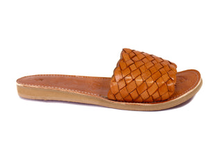 Side view of honey colored leather woven slide sandal with floral imprint on the innersole