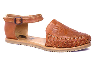 Side view of Honey colored leather closed toe sandal with an ankle buckle and a sunflower imprint on the face