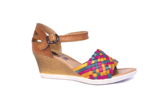 Side view of leather wedge sandals with a bright multicolored strap and an ankle buckle